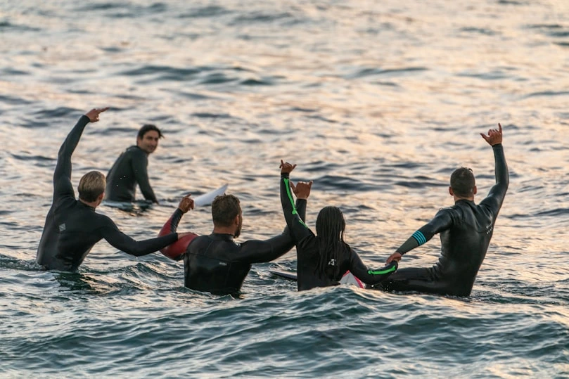 Des nageurs dans un océan célèbrent une victoire